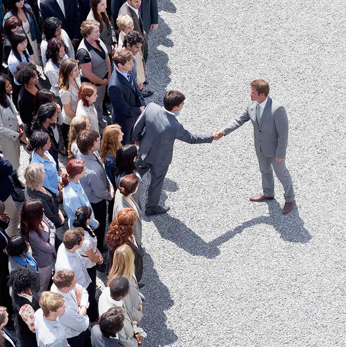 image of one man being greeted by a group of people